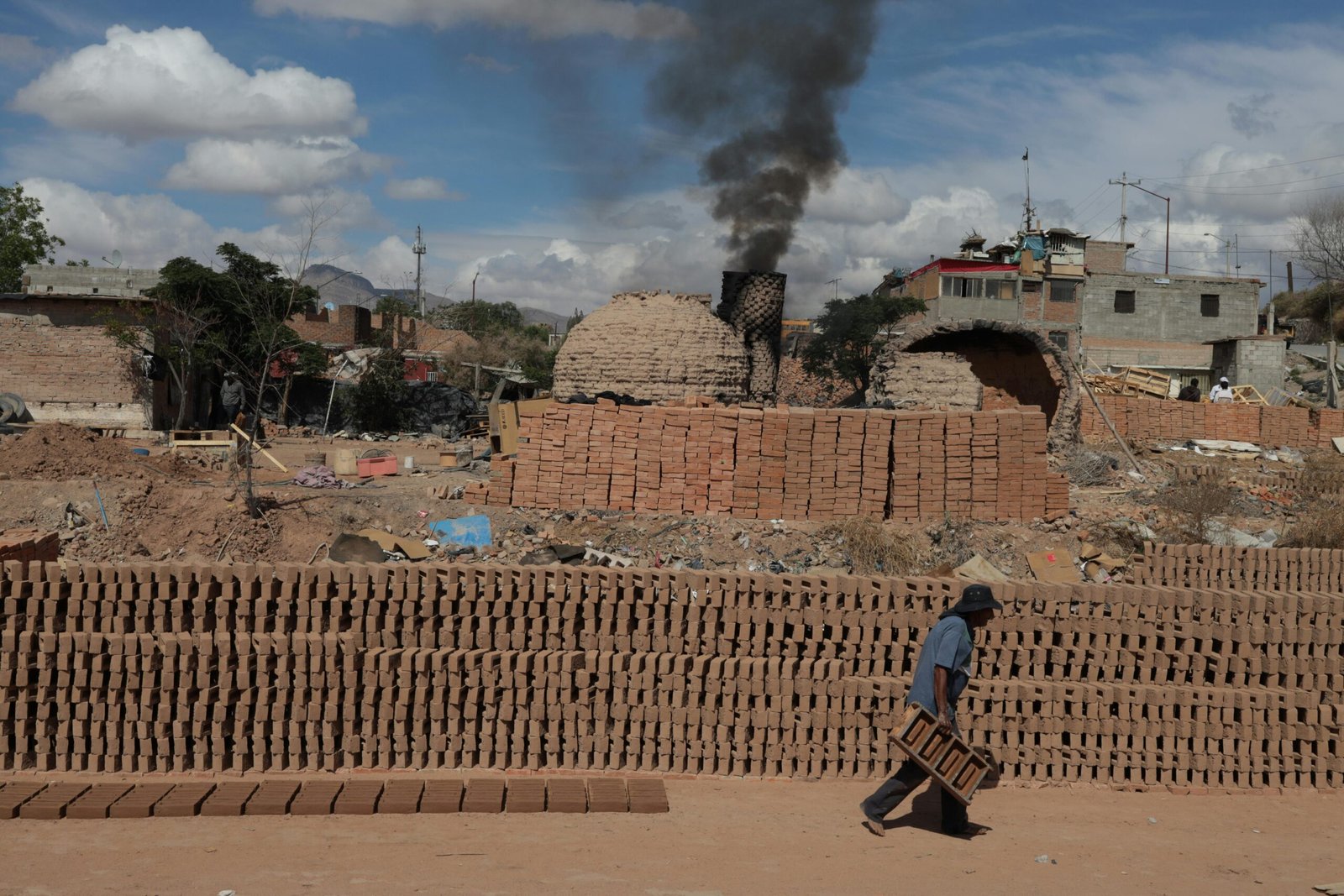 A man working in a brick manufacturing area in Ciudad Juárez, Mexico.